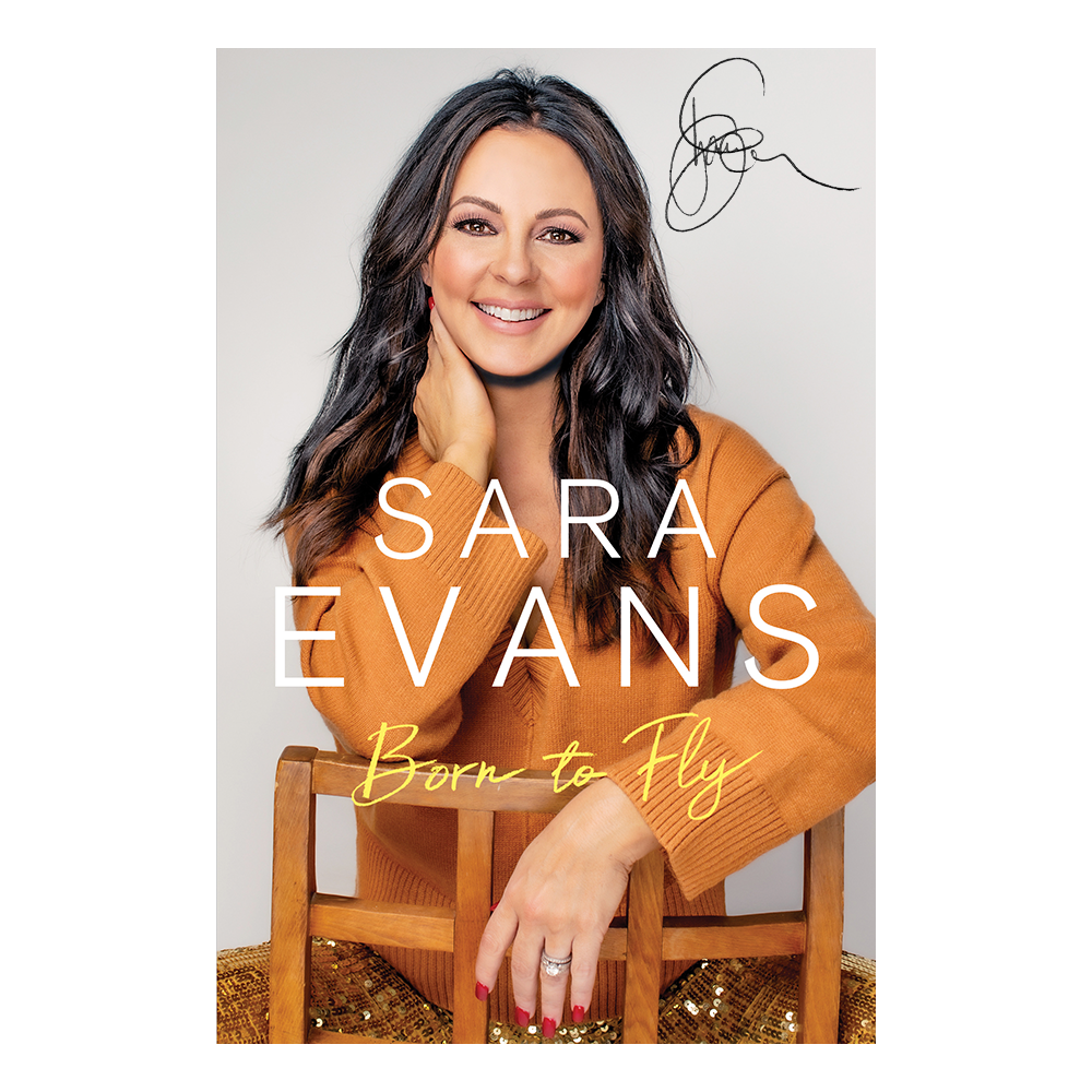 Book cover featuring a woman in an orange sweater with 'Sara Evans Born to Fly' text.