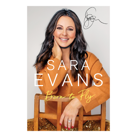Book cover featuring a woman in an orange sweater with 'Sara Evans Born to Fly' text.